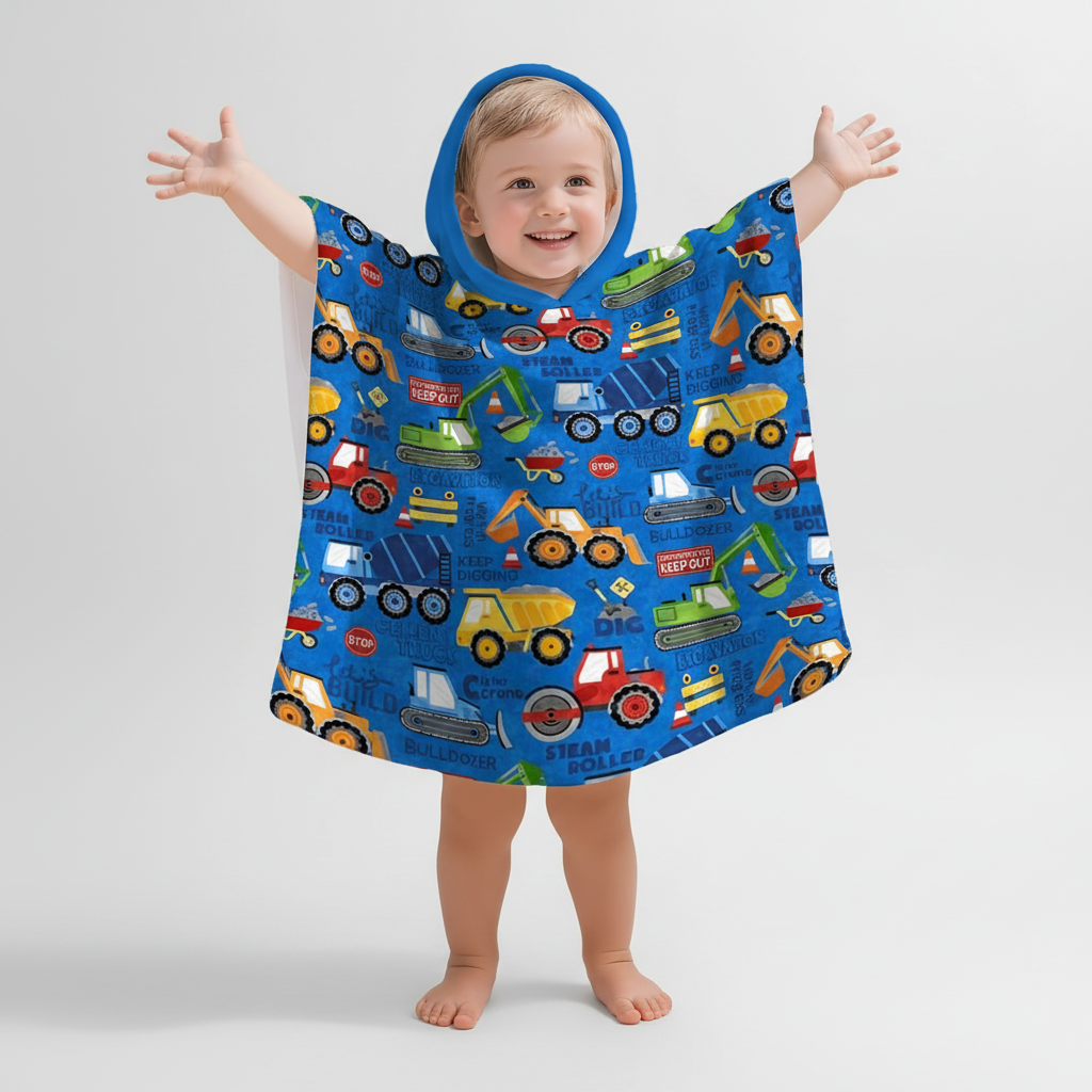 Child modeling a construction print hooded poncho, emphasizing vibrant design and comfortable playwear.