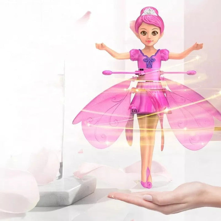 Hand gesturing to control a glowing magical flying drone, showcasing its interactive features for kids