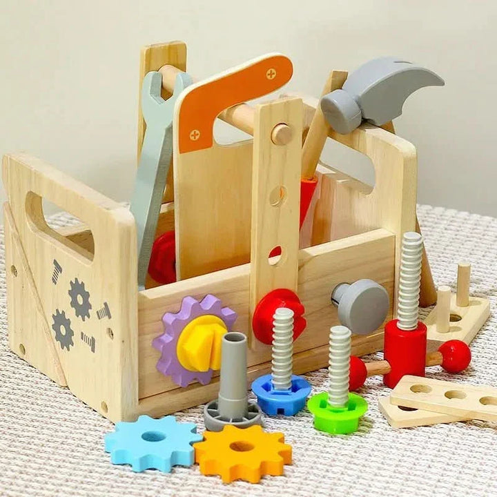 Toddler using wooden hammer & screwdriver from a Montessori tool kit, enhancing fine motor skills & pretend play.