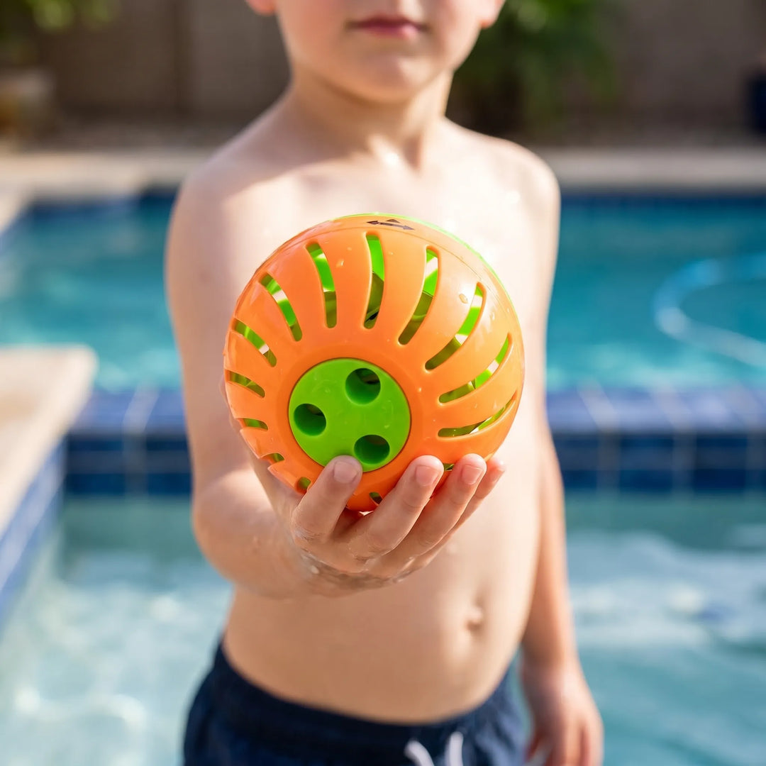Kids' outdoor water balloon passing game with colorful launchers for summer backyard fun & party activity.