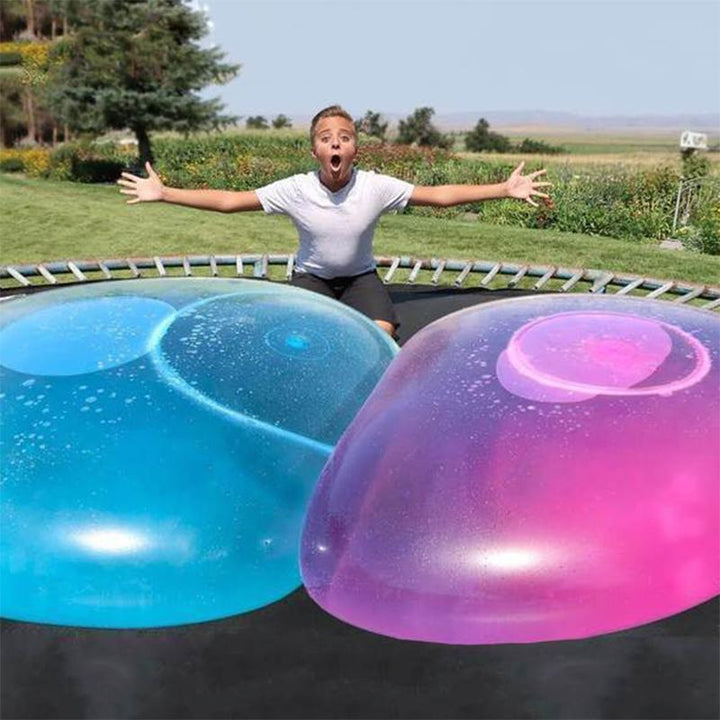 Kids playing with a giant tear-resistant inflatable bubble ball outdoors for summer fun.