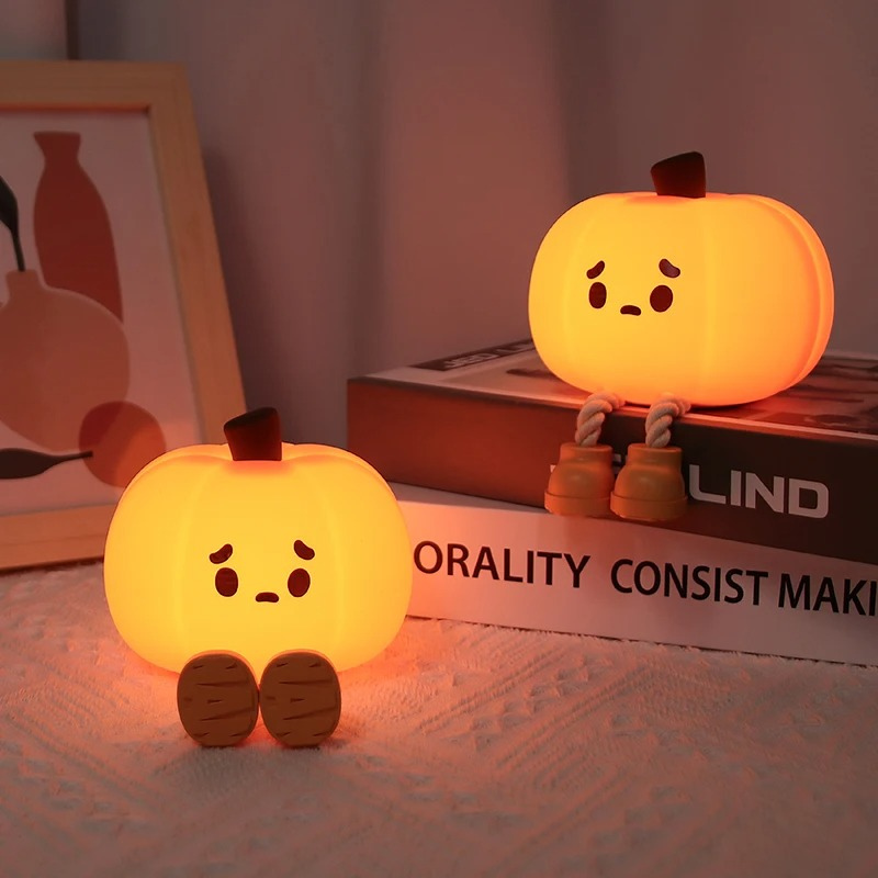 Kids' pumpkin night light with soft glow, safe for bedtime. Perfect nursery decor & child-safe bedside lamp.