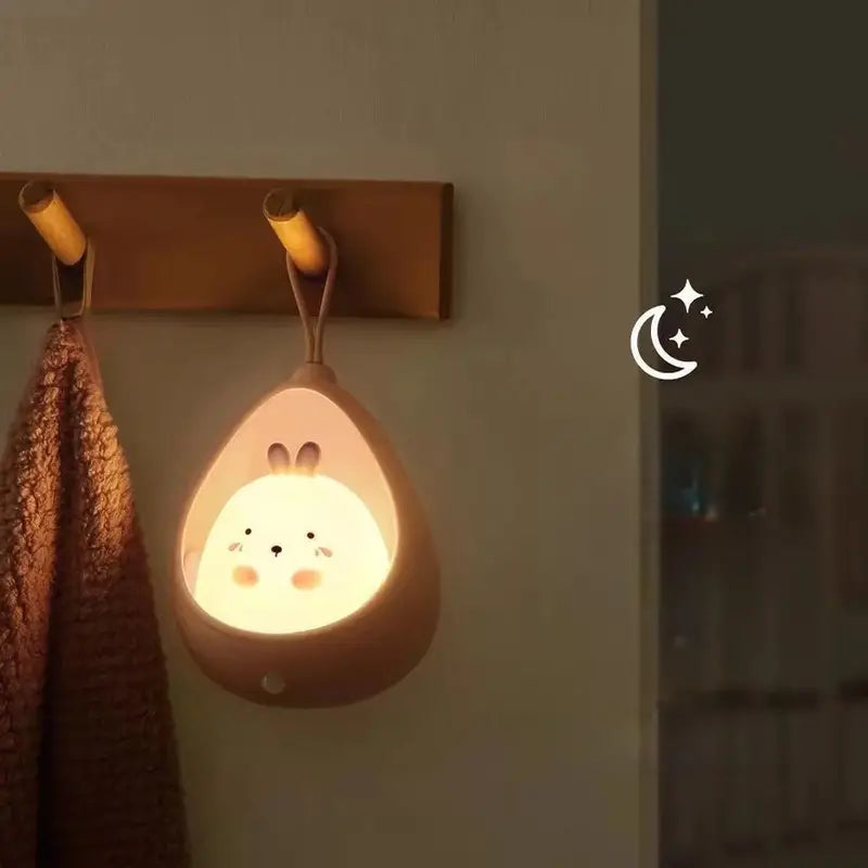 Soft glow rabbit LED night light, rechargeable & motion sensor, ideal for children's bedside.
