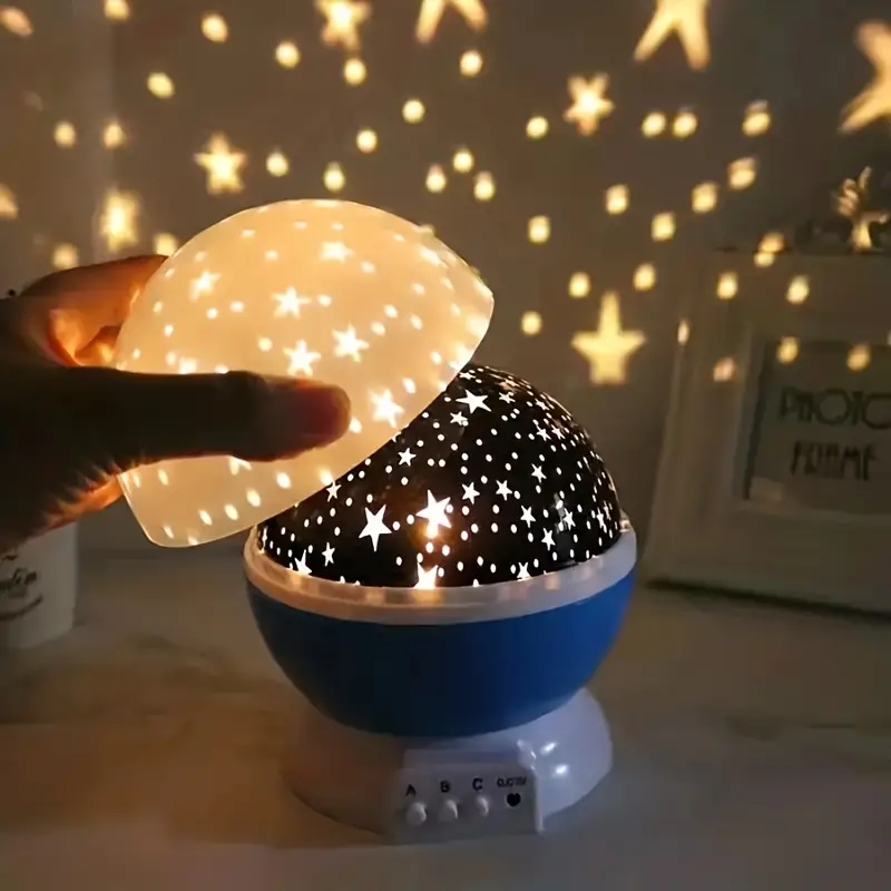 Kids' star projector night lamp, creating a magical starry sky. Perfect for bedrooms & nursery decor.