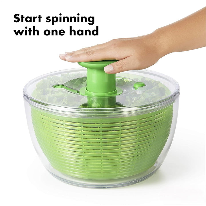Overhead view of a large salad spinner with a white basket, great for vegetable drying.