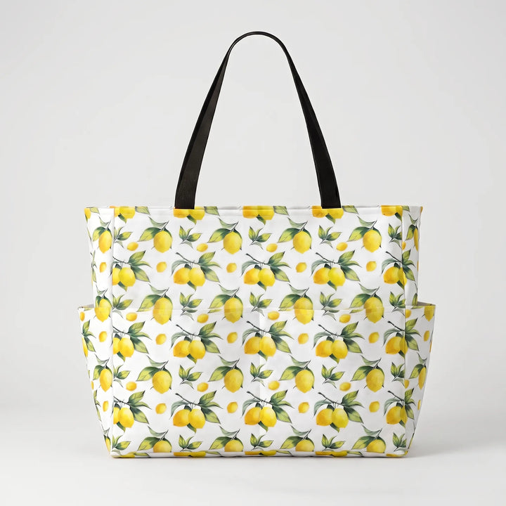 Close-up of vibrant tropical lemon print on a large women's beach tote, ideal for summer vacation.
