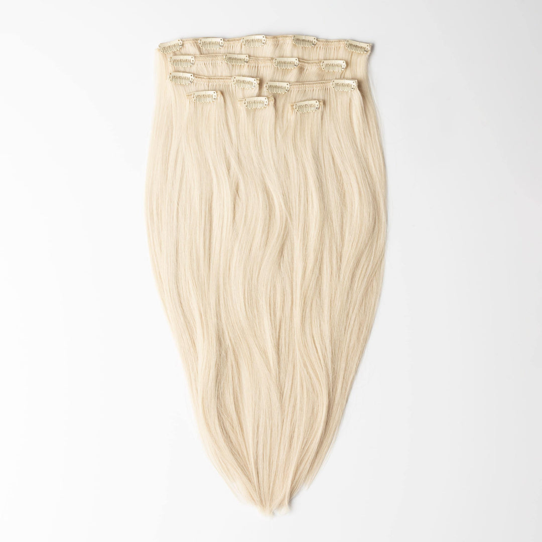 Light Ash Blonde clip-in human hair extensions for women, adding natural volume & length.