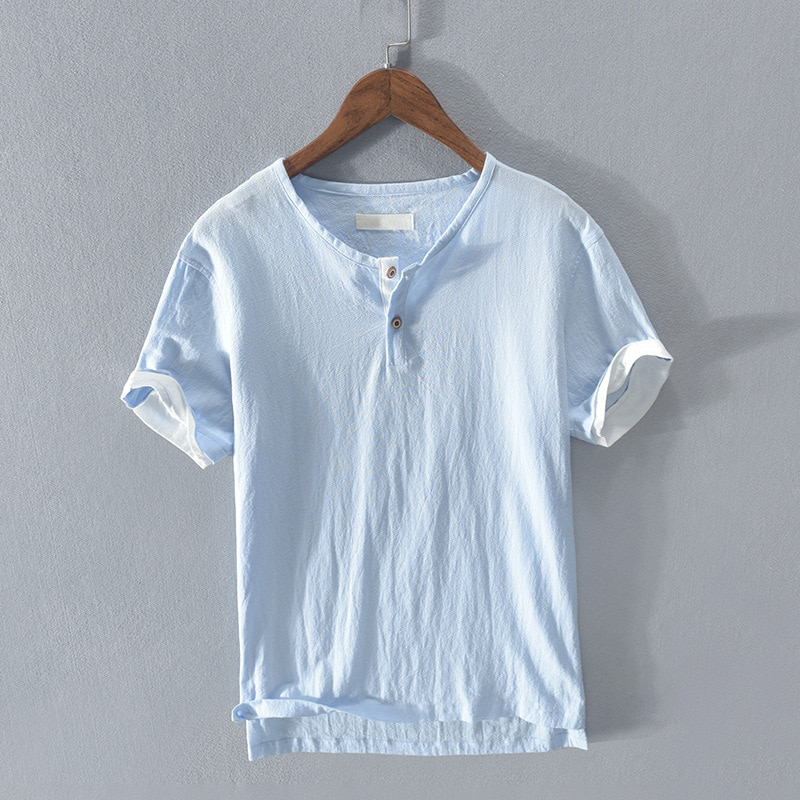Light blue men's relaxed fit henley shirt, perfect for warm summer days. Comfortable short sleeve casual wear.