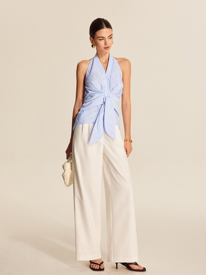 Stylish women's sleeveless striped halter blouse, featuring a trendy tie front. Ideal for office wear or a casual chic look.