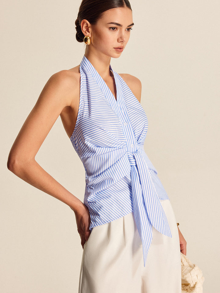Elegant light blue striped halter top for women. This sleeveless blouse boasts a fashionable tie front, great for workwear.