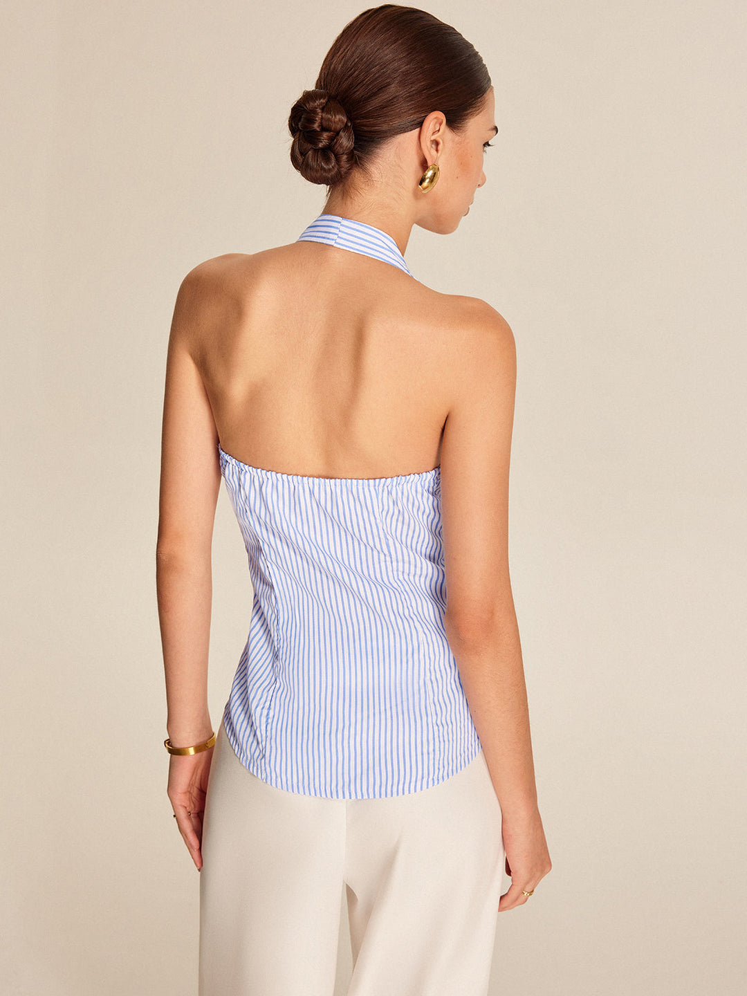 Comfortable women's striped light blue halter top. Sleeveless and tie front, offering a versatile casual chic style.