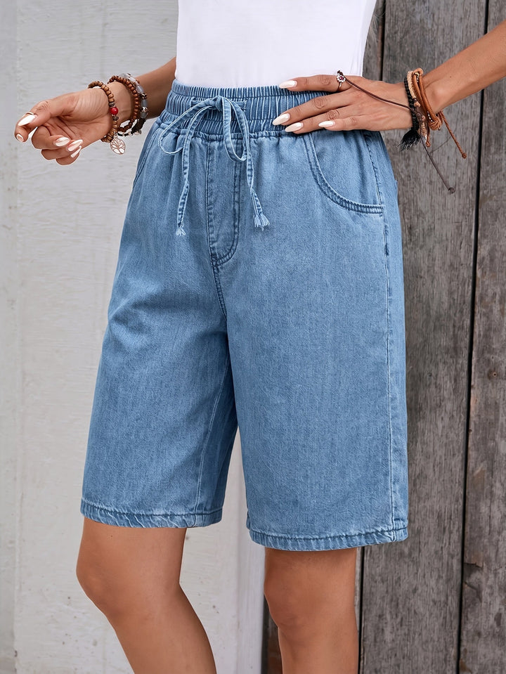 Casual light blue bermuda shorts for women, ideal for summer fashion, offering a comfortable and versatile relaxed fit.