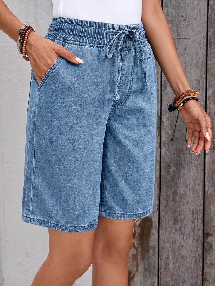 Relaxed fit light blue women's bermuda shorts, designed for comfort with an elastic waist for easy summer wear.