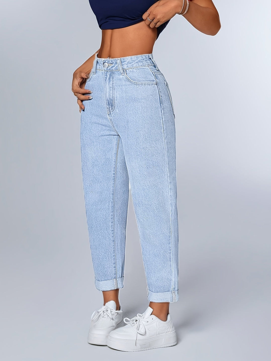 Light blue women's mom jeans, high waist & tapered leg. Relaxed fit for casual, retro everyday style.