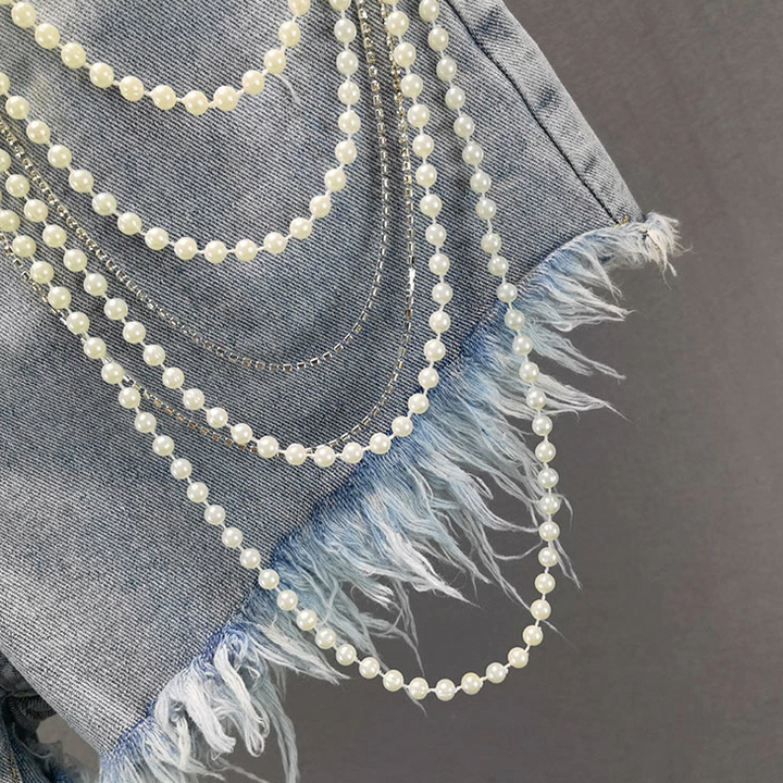 Trendy women's light blue pearl tassel shorts. Comfortable, casual, and stylish for summer chic & vacation.