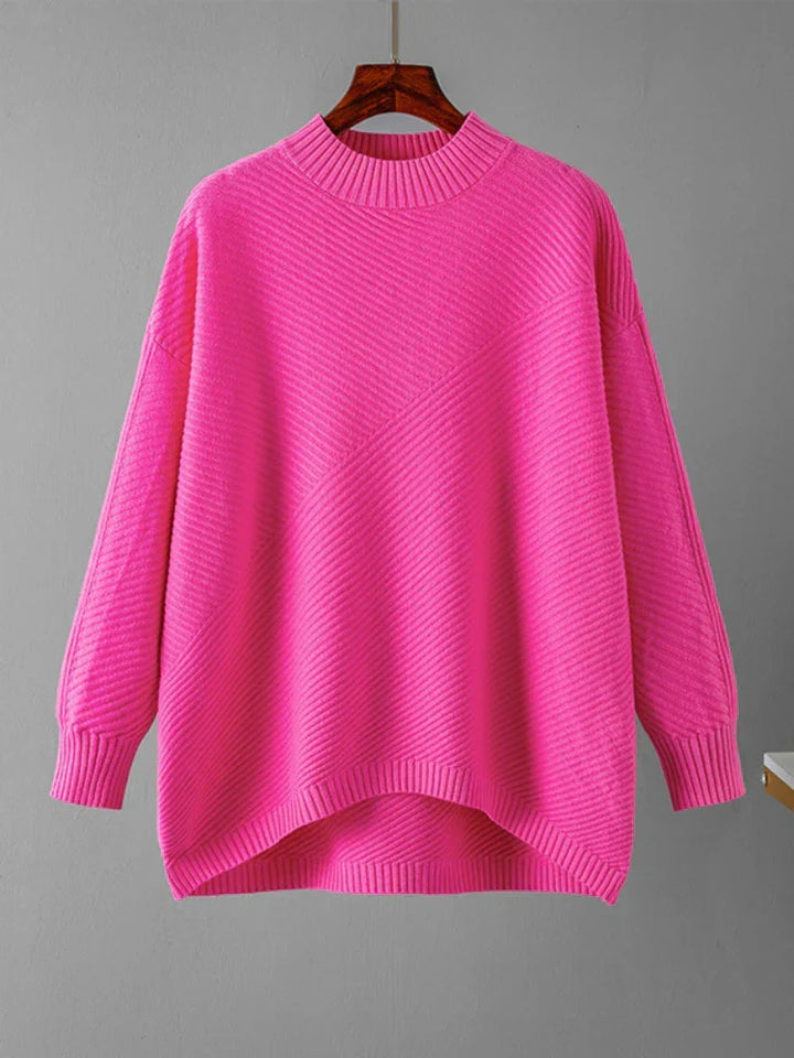 Pink ribbed knit women's sweater. Classic round neck design, versatile for casual fashion.