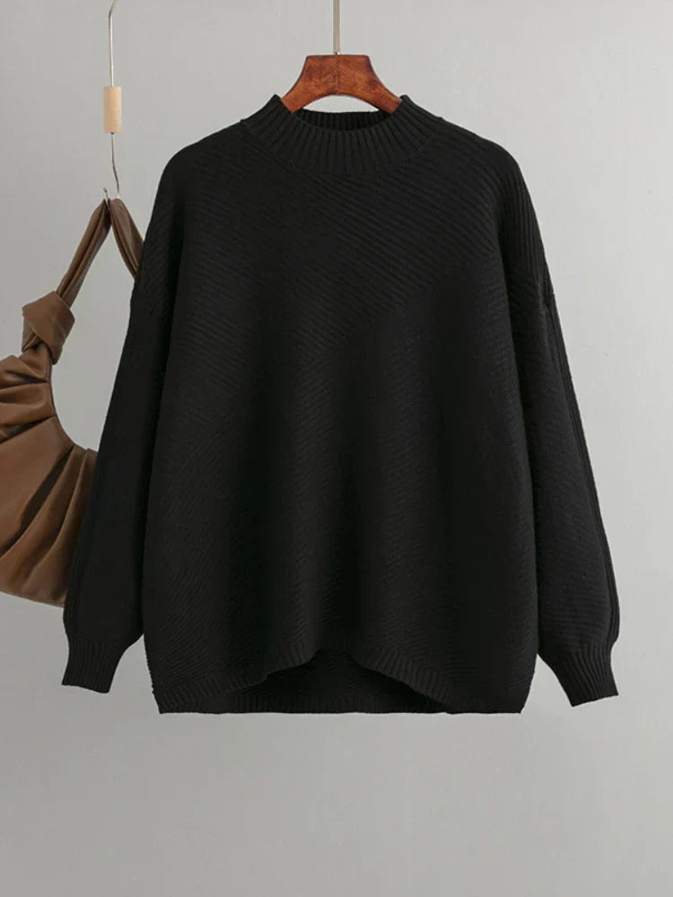 Black oversized knit women's sweater. Classic ribbed design, round neck, comfortable casual top.