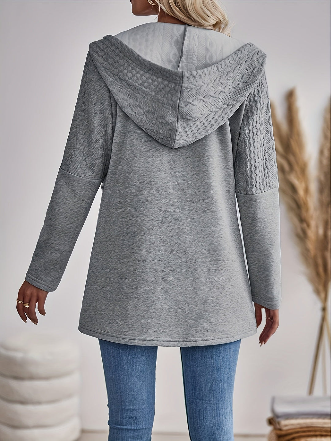 Stylish women's textured zip-up hoodie in light grey. A versatile hooded jacket for casual spring & autumn wear.