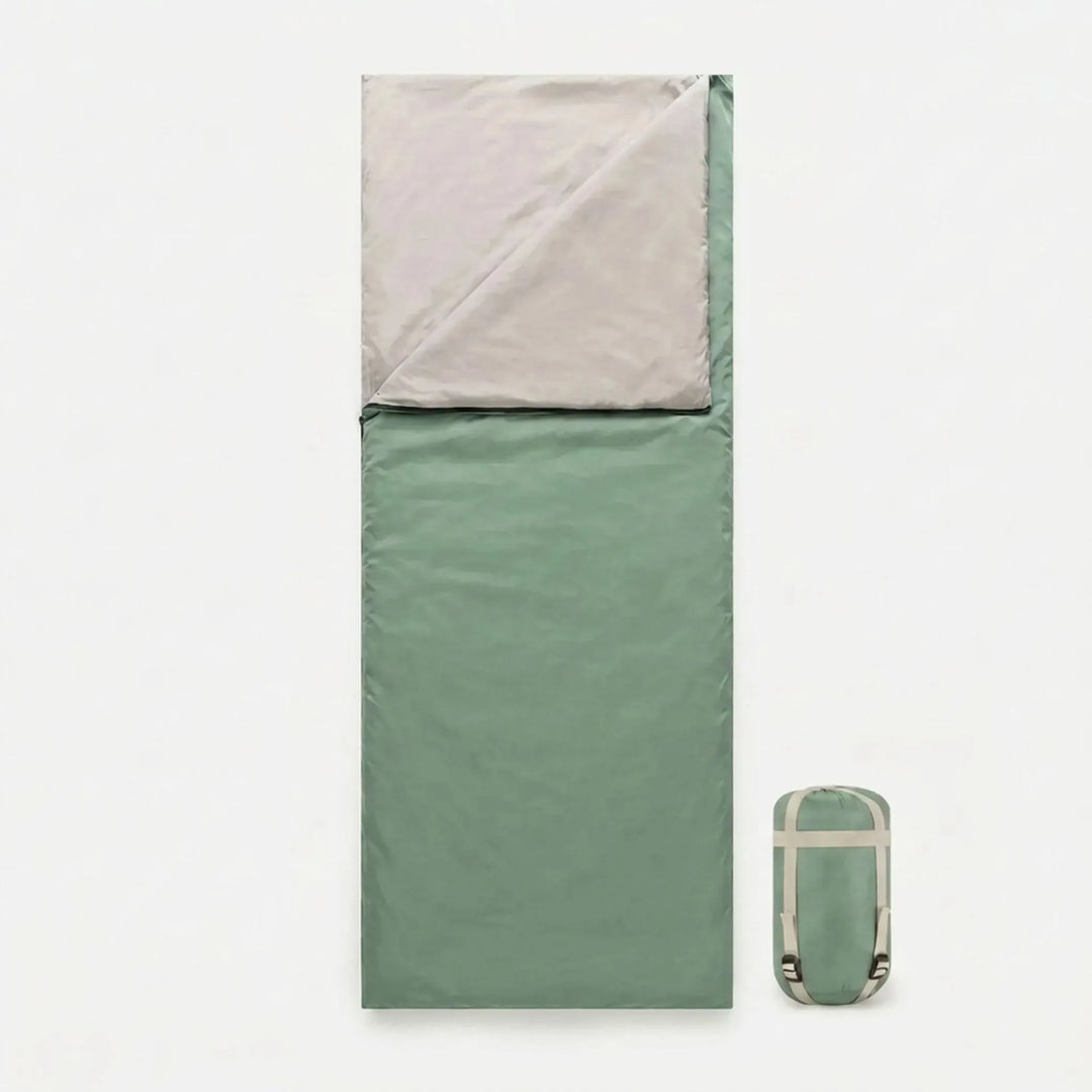 Rolled brown sleeping bag in its stuff sack, showcasing its compact design for easy transport.