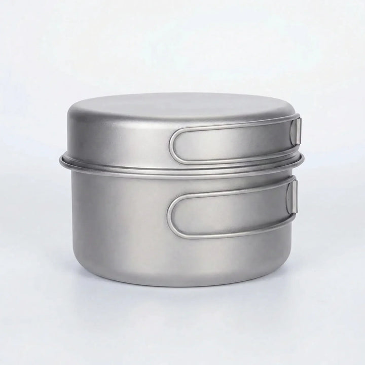 Durable titanium pot set for backpacking, hiking, and travel; features space-saving folding handles.
