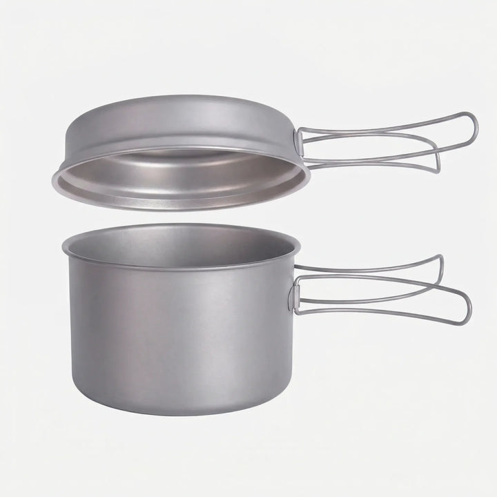 Ultralight titanium camping cookware set for backpacking, featuring durable pots with convenient folding handles.
