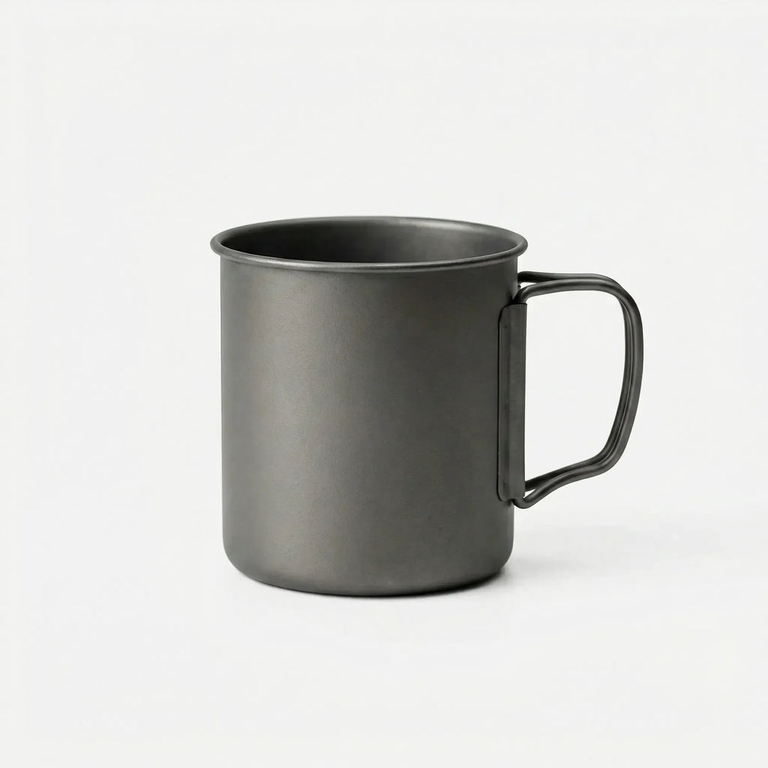 Durable titanium outdoor cup with compact foldable handle, ideal for travel, bushcraft, and survival kits.