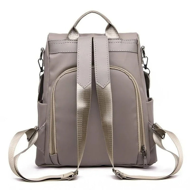 Versatile water-resistant nylon backpack for women, shown in its multi-way configuration, minimalist design