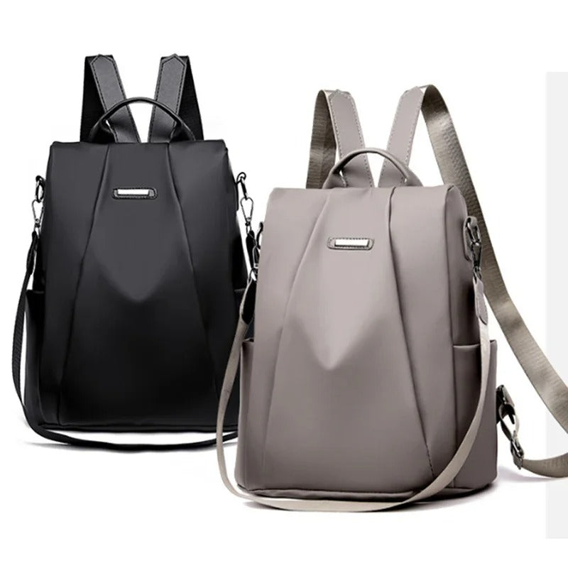 Women's travel backpack in water-resistant nylon, demonstrating its multi-way carry as a crossbody bag