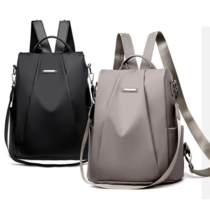 Women's travel backpack in water-resistant nylon, demonstrating its multi-way carry as a crossbody bag