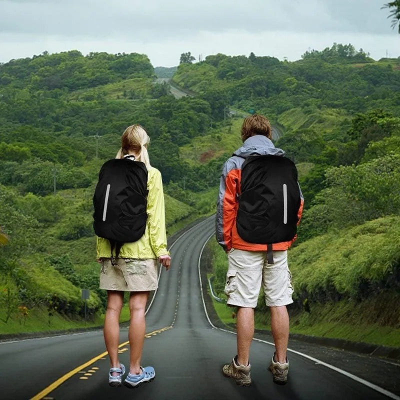 Lightweight waterproof backpack rain cover with reflective strips, protecting a hiking backpack from rain.