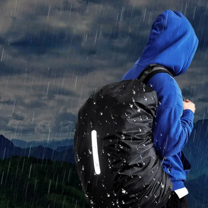 Water beading off the waterproof surface of a backpack rain cover, illustrating its excellent rain protection.