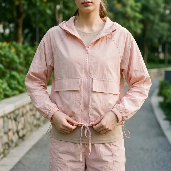 Lightweight women's hooded sports jacket for running, hiking, or everyday outdoor activities.