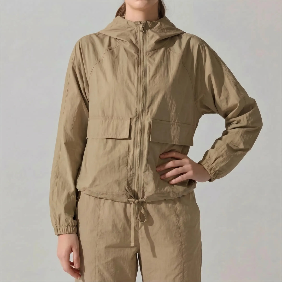 Women's lightweight hooded sports jacket, an essential windbreaker for outdoor running & training.