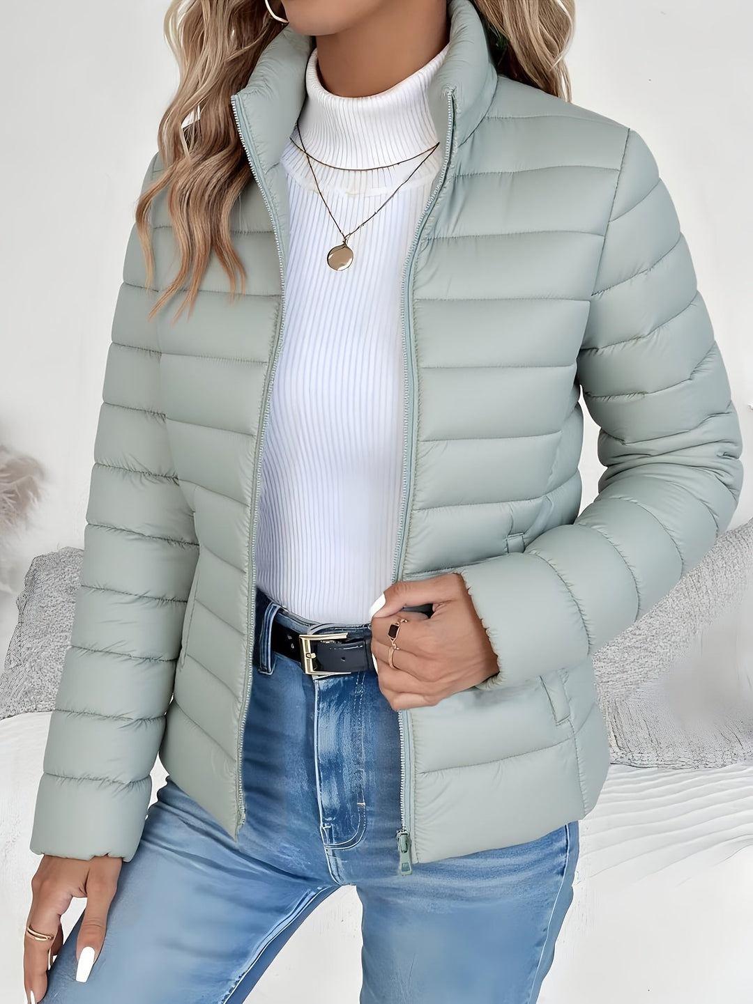 Lightweight women's quilted jacket with stand collar & zip closure. Perfect fall/winter outerwear for everyday style.