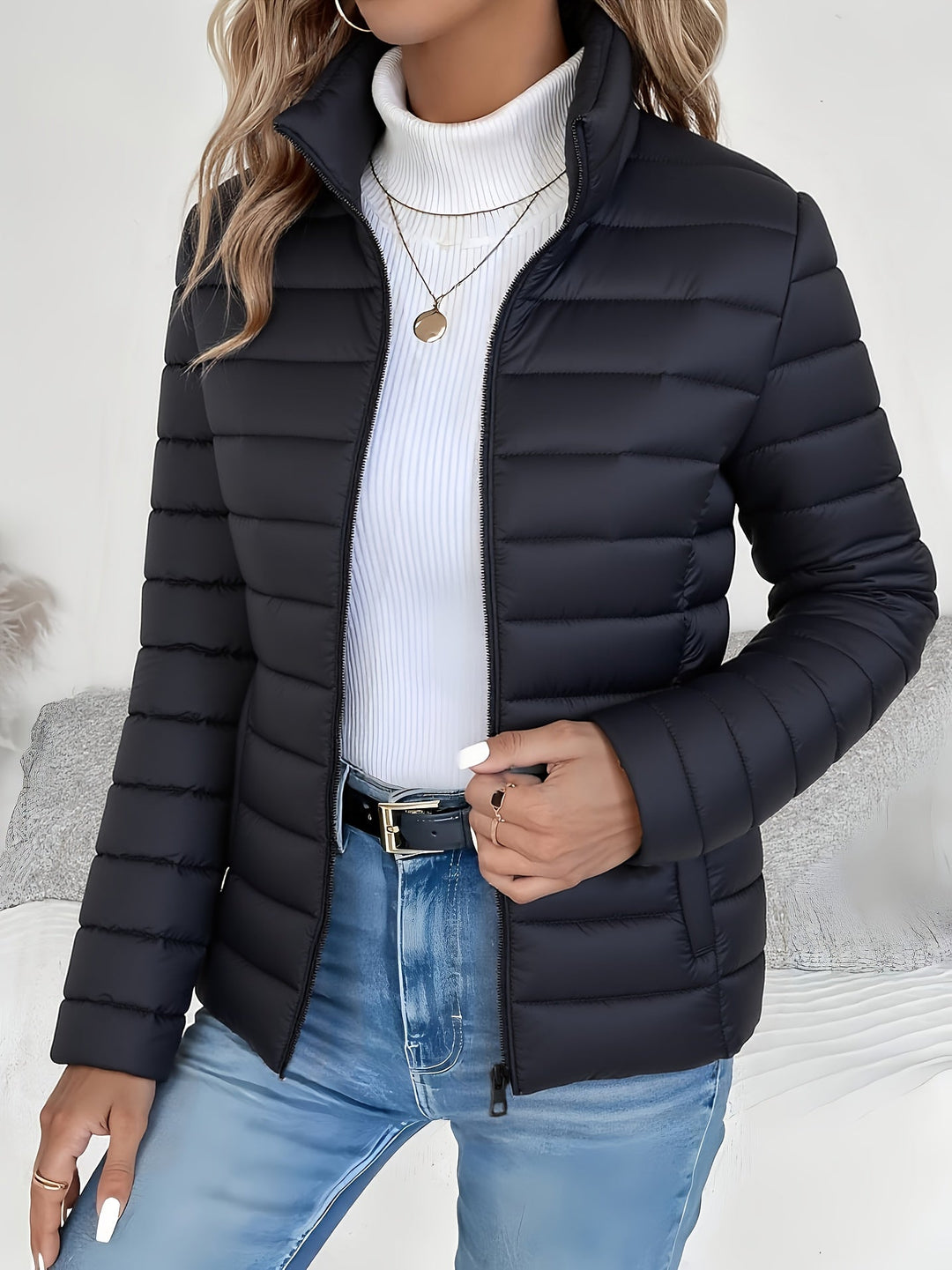 Stylish women's lightweight quilted jacket. Long sleeve, stand collar, zip front. Versatile outerwear for cool fall and winter days.