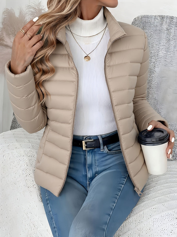 Women's winter jacket: lightweight quilted design, stand collar, zip closure. Versatile everyday outerwear for women.