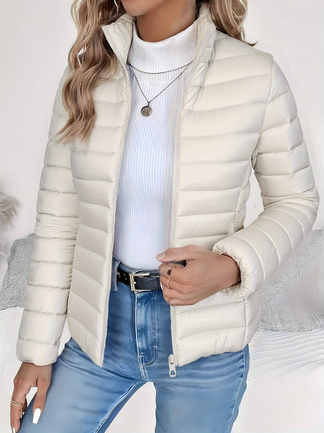 Trendy women's quilted jacket with a chic stand collar and zip front. A lightweight, long sleeve piece for fall/winter style.