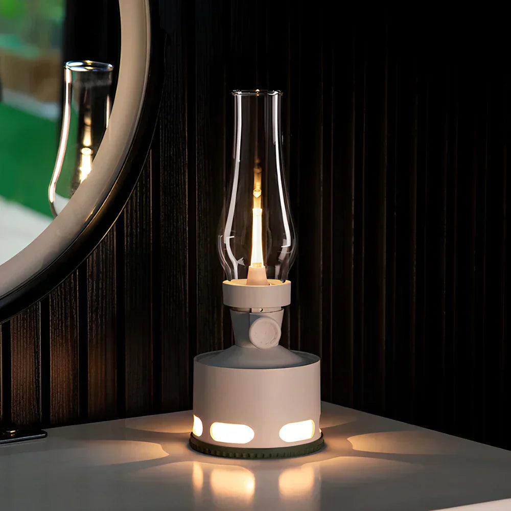 Outdoor scene with a LumaLantern rechargeable vintage LED lantern hanging from a tree branch, portable ambiance