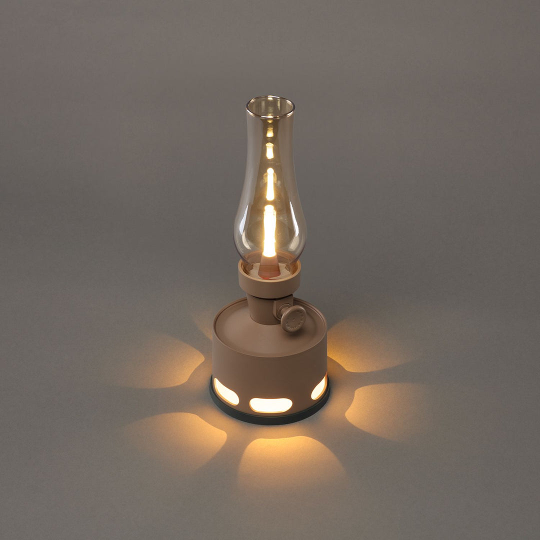 LumaLantern vintage LED lantern next to a tent, an essential rechargeable camping lamp for outdoor adventures