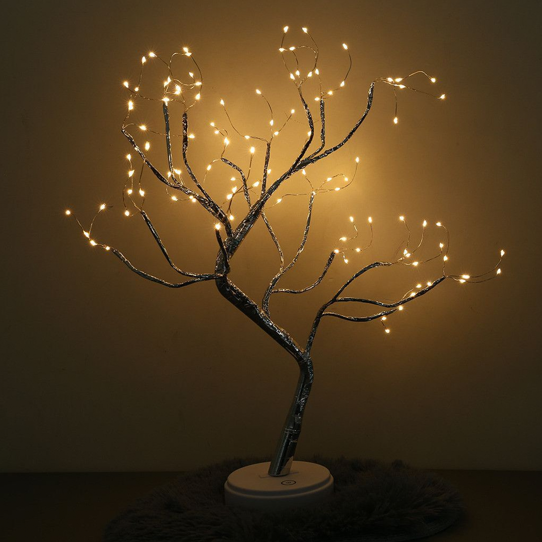 Close-up of a LumaTree LED tree lamp showcasing delicate fairy lights on its branches, serving as a charming table lamp.