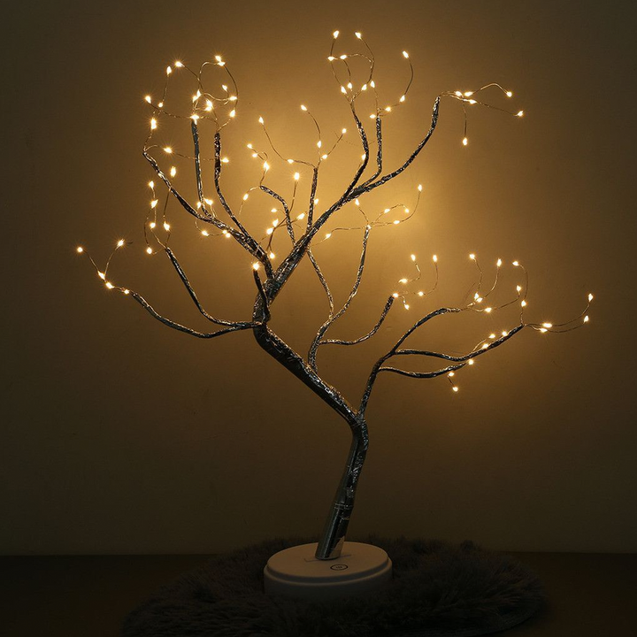 Close-up of a LumaTree LED tree lamp showcasing delicate fairy lights on its branches, serving as a charming table lamp.