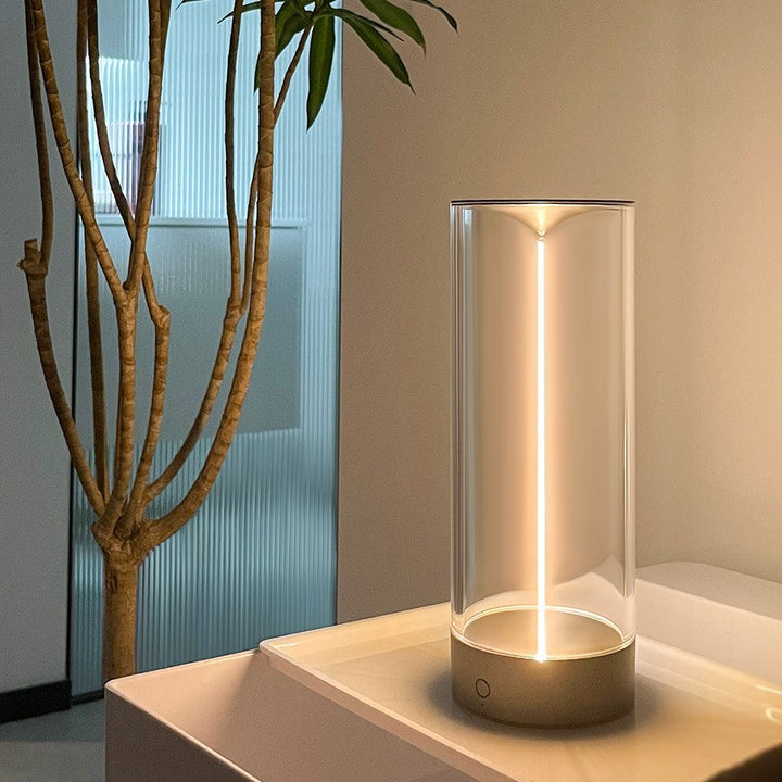 Rechargeable LumenFlow mood lamp, illuminating a cozy reading nook with soft, warm light