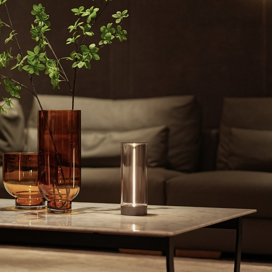 LumenFlow wireless mood lamp, portable and versatile, placed on an outdoor patio table at dusk