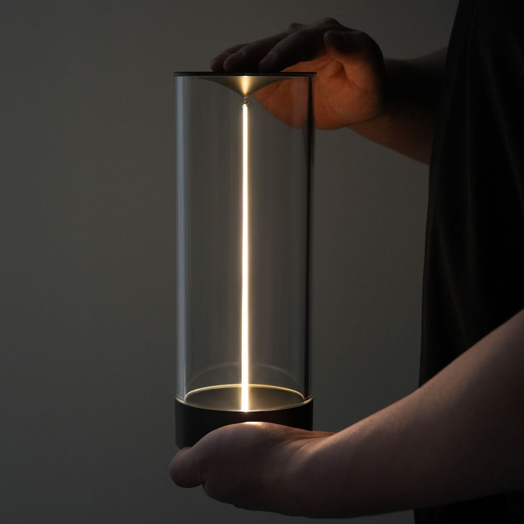 Top-down view of the LumenFlow magnetic light strand, detaching from the modern LED lamp base