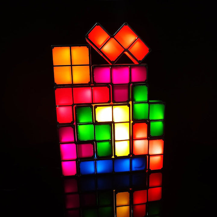 Interactive LED Tetris lamp illuminating a dark room, showcasing its modular design and bright, colorful glow