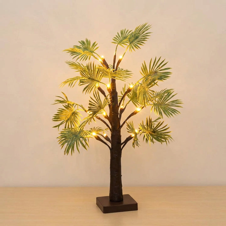 Battery-operated LED palm tree night light, casting a warm glow, ideal for tropical decor.