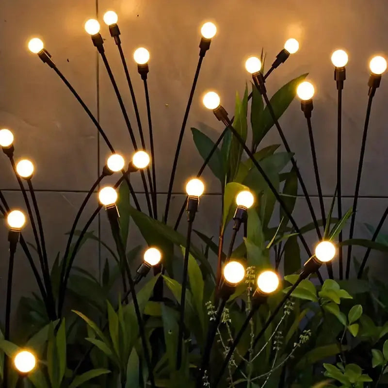 Multiple LunaGlow solar lights creating beautiful automatic LED garden and landscape illumination at night.