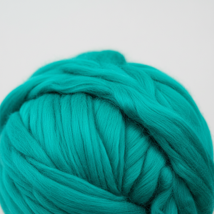 Soft, chunky wool yarn for knitting & crochet, shown unwound, highlighting its plush texture.