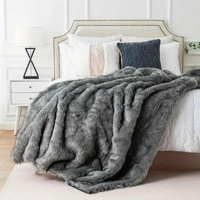 Ultra-soft faux fur throw blanket, a luxurious & warm decorative accent to enhance any cozy home decor.