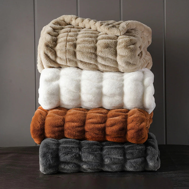 Luxurious faux fur throw blanket, soft and plush for elegant home comfort.